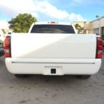 A white truck parked in the parking lot.